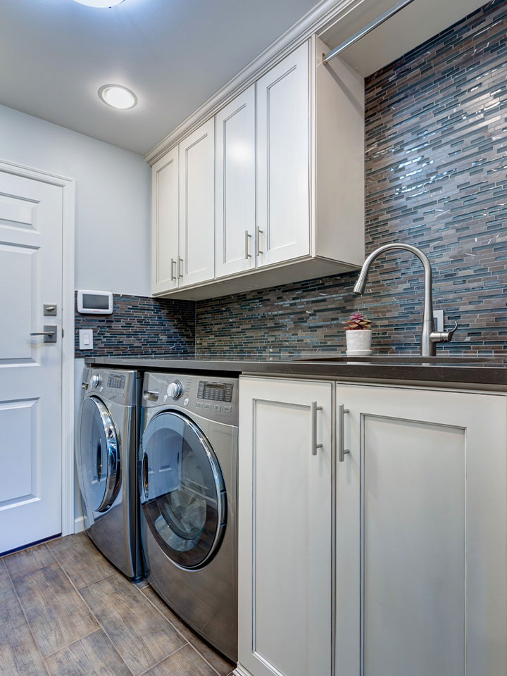 anm-contracting-projects-laundry-room-White-laundry-room-boasts-white-shaker-cabinets