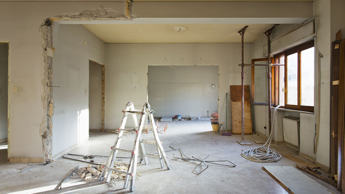 Unfinished Interior of a home with scaffold and ladder
