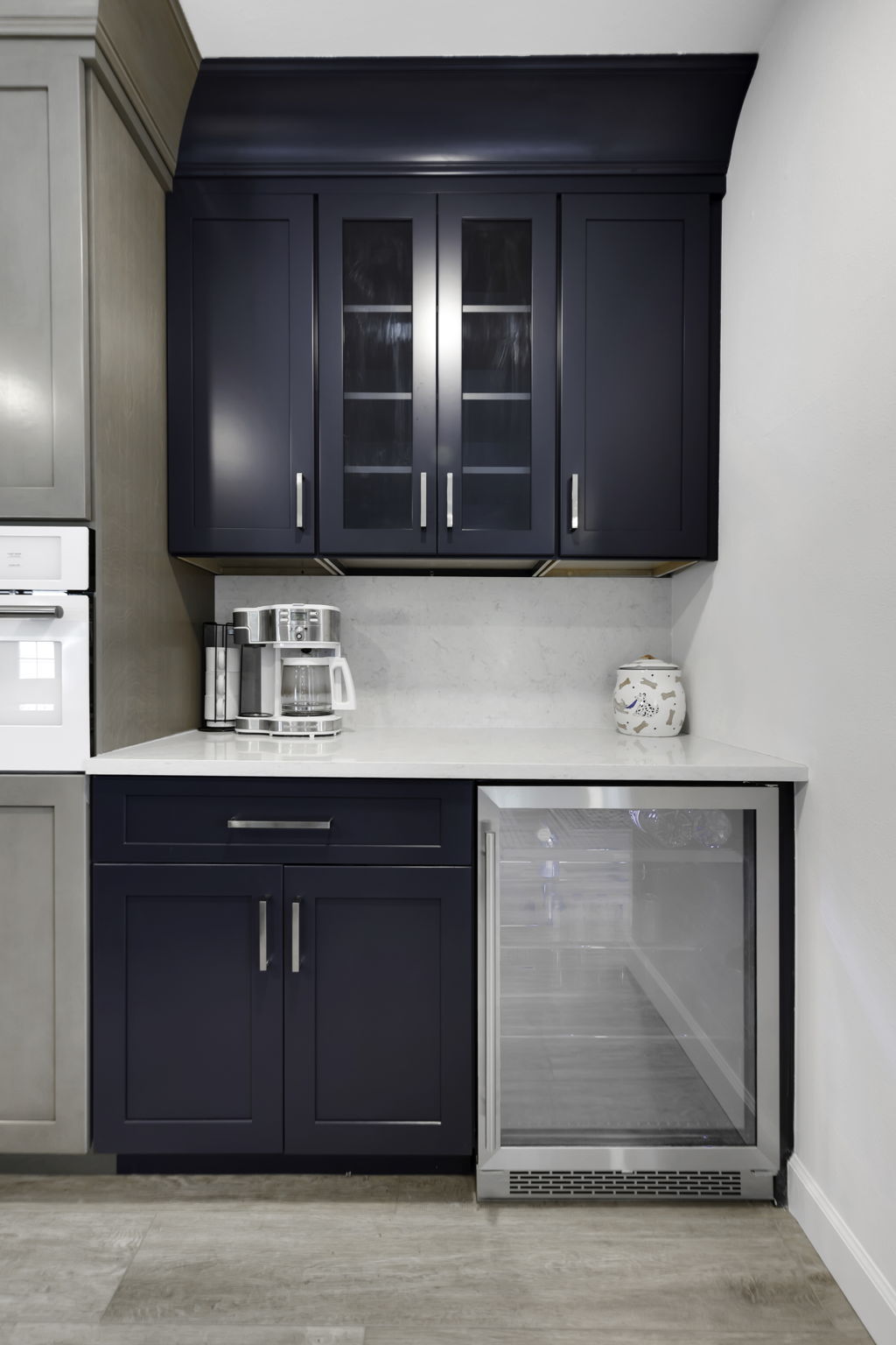 Luxury kitchen remodel with white cabinets and farmhouse sink facing living room
